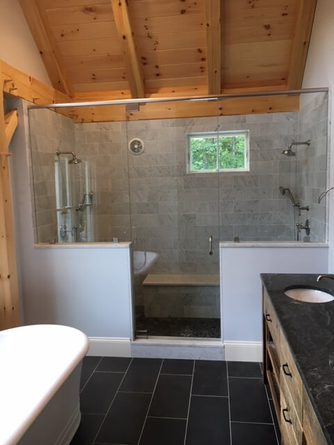 Custom tiled walk-in shower with glass enclosure