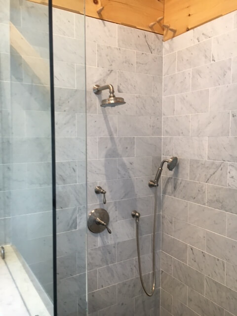 Marble tile shower with brushed nickel fixtures