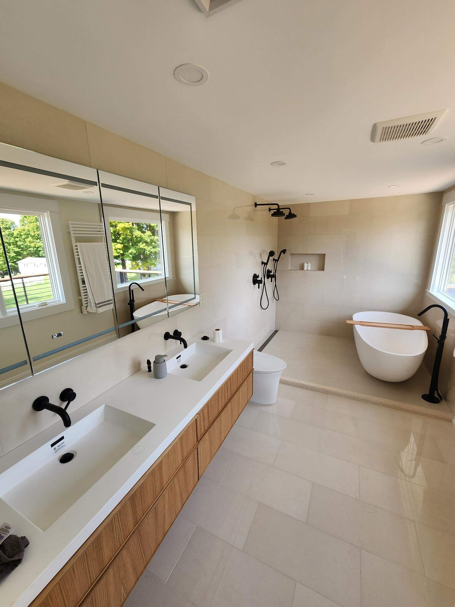 Modern bathroom with dual vanity and freestanding tub